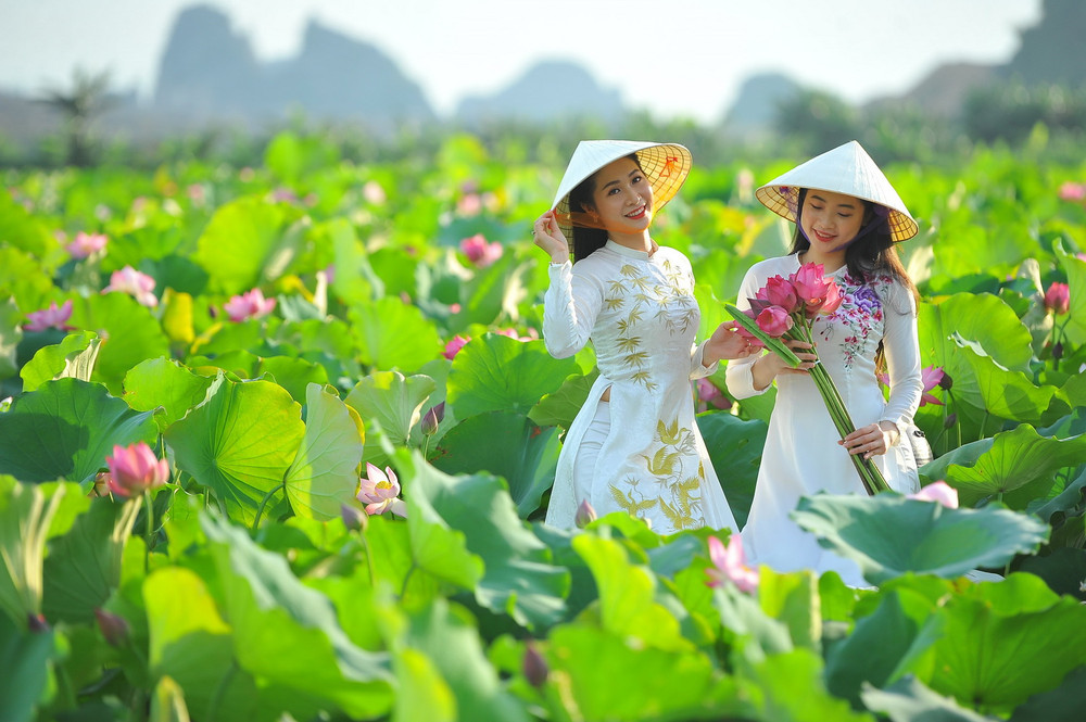 Lotus Season in Ninh Binh: Exploring the Paradise of Flowers 11 Rent "Ao Dai" with conical hat - Being Vietnamese people